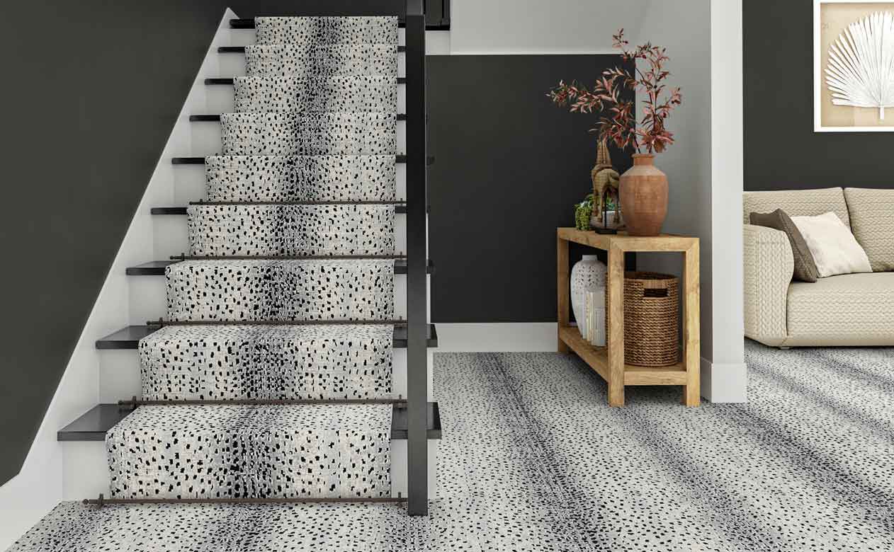 print patterned carpet in modern foyer with staircase and gray accent wall